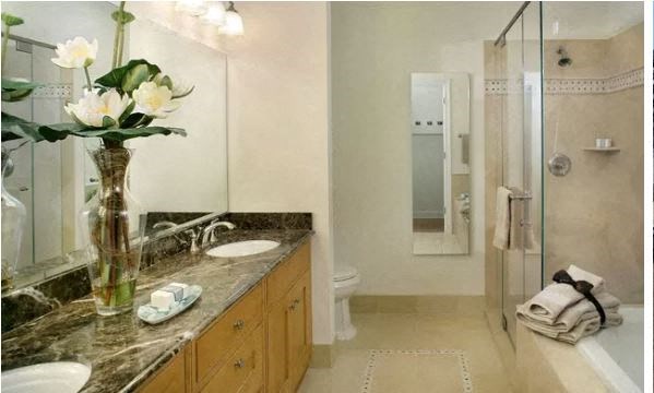 a bathroom with a vase of flowers on a counter