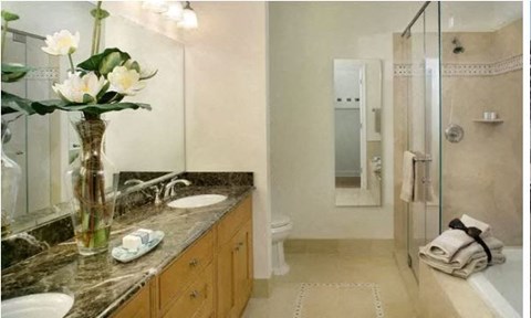 a bathroom with a vase of flowers on a counter