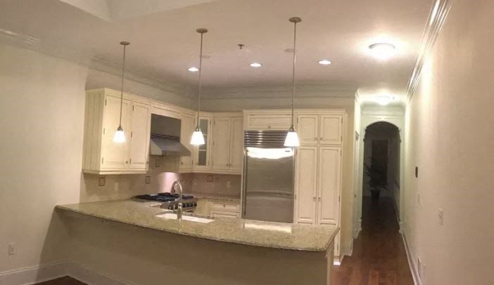 a kitchen with white cabinets and a counter top