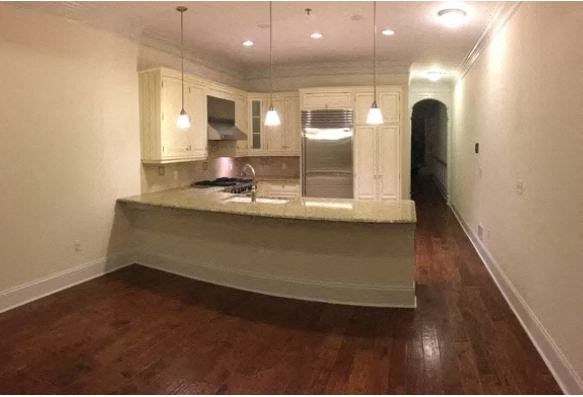 a large kitchen with a counter top and a sink
