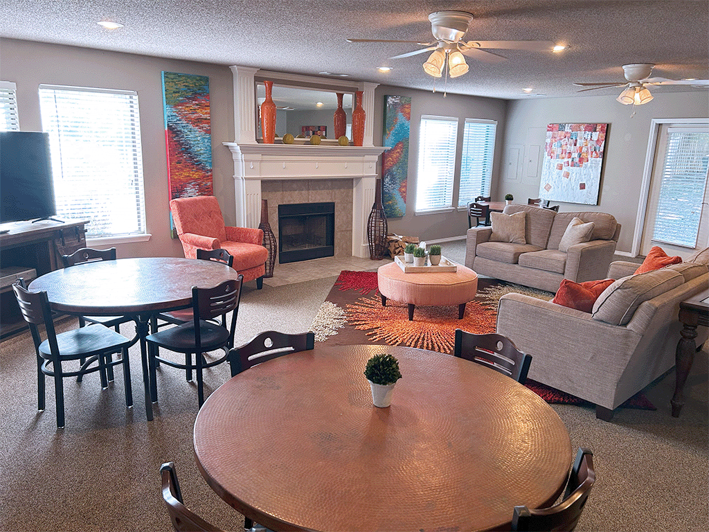a living room with a table and chairs and a fireplace