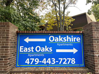 a sign apartments is displayed on a brick wall