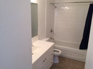 A white bathroom with a toilet and sink.