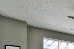 Village on Redwood interior bedroom with large window and ceiling fan