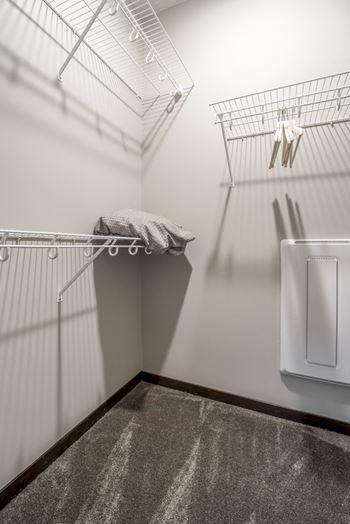Empty walk in closet with wire shelving for hanging clothes