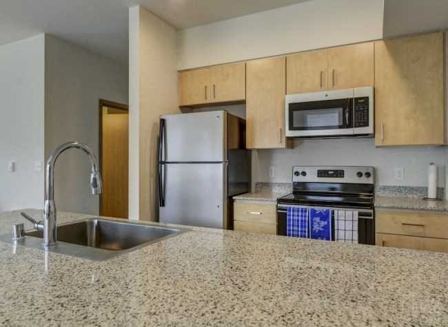 a kitchen with stainless steel appliances and a granite counter top