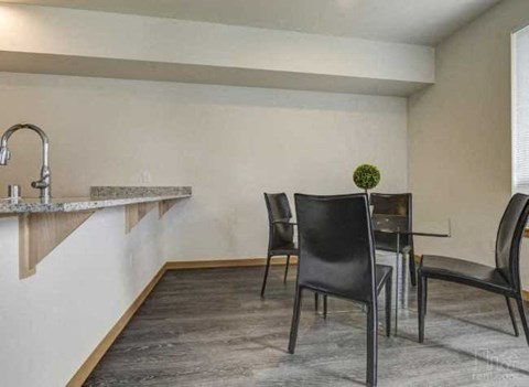 a dining room with a table and chairs