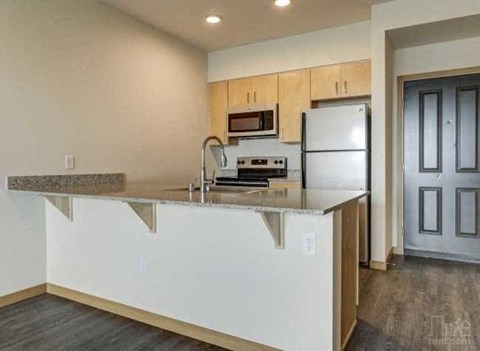 a kitchen with a counter top and a refrigerator