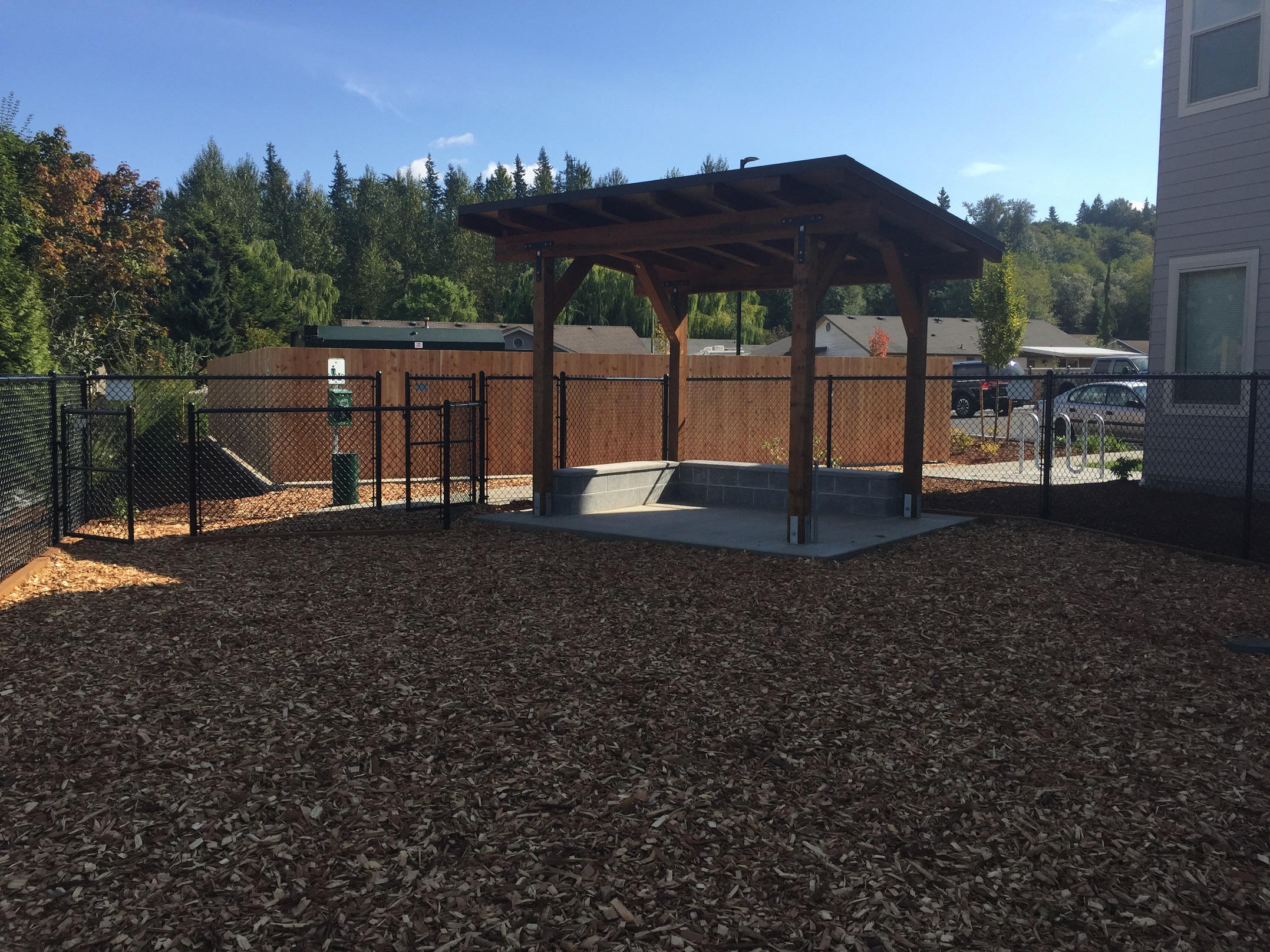 a patio with a fenced in area and a pool