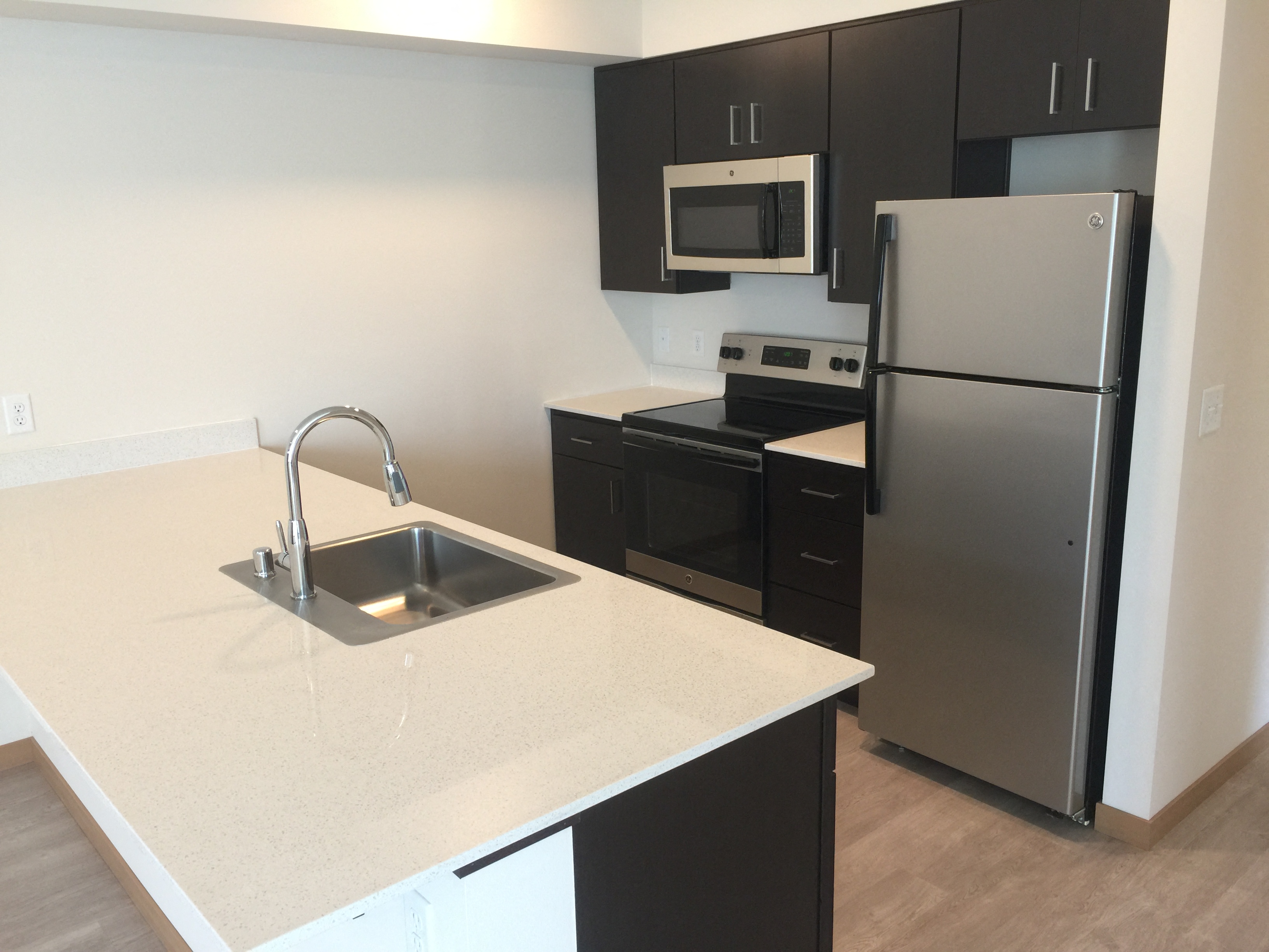 a kitchen with a sink and a refrigerator