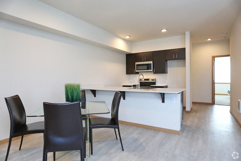 a kitchen and dining room with a table and chairs