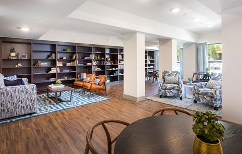 A living room with a black table and chairs.