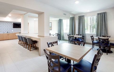 A dining room with a long table and chairs.