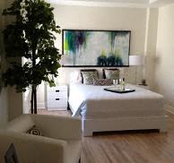 a bedroom with a bed and a tree