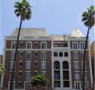 a large building with palm trees in front of it