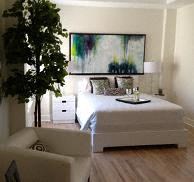 a bedroom with a bed and a tree