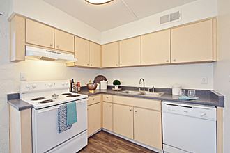 a large kitchen with white appliances and cabinets