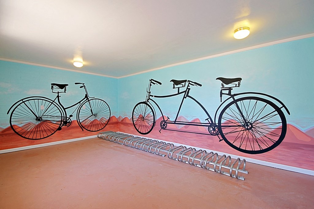 three bikes painted on the wall of a room
