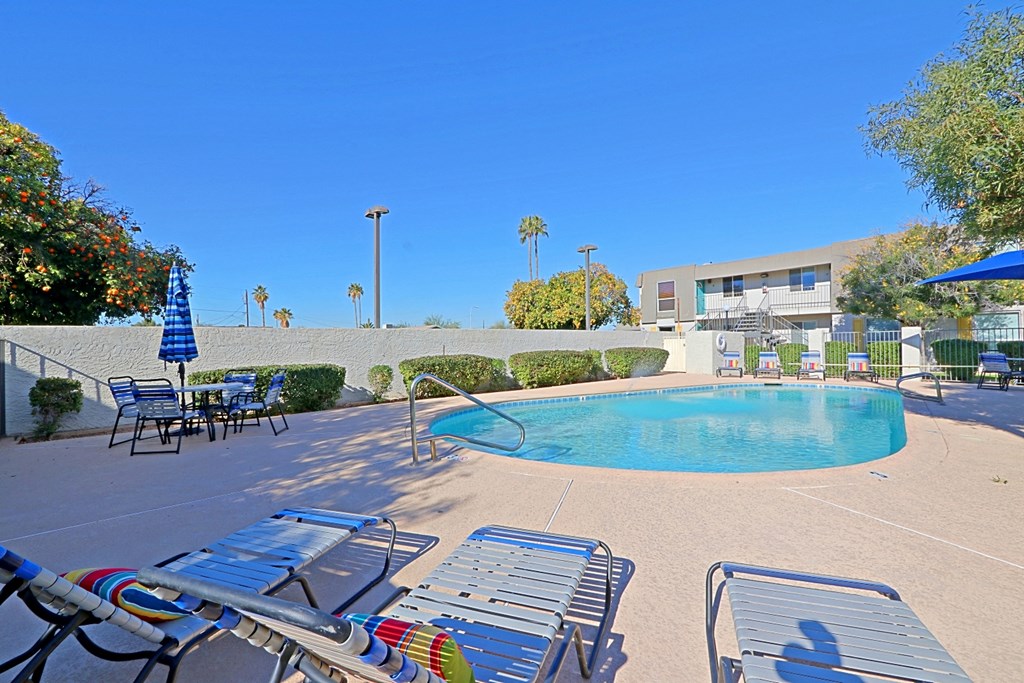our resort style pool is next to our building and has chairs and umbrellas