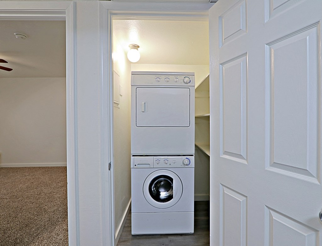 an empty laundry room with a washer and dryer