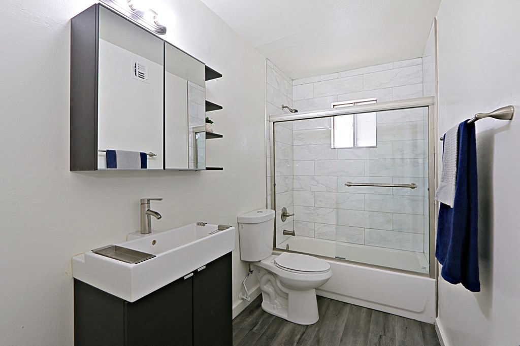 a bathroom with a toilet sink and shower