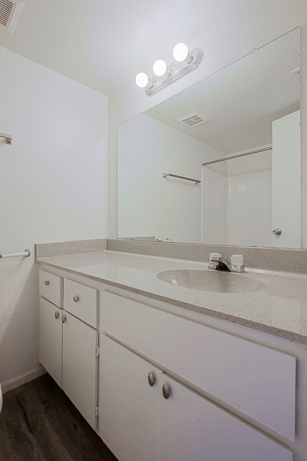 an empty bathroom with a sink and a mirror