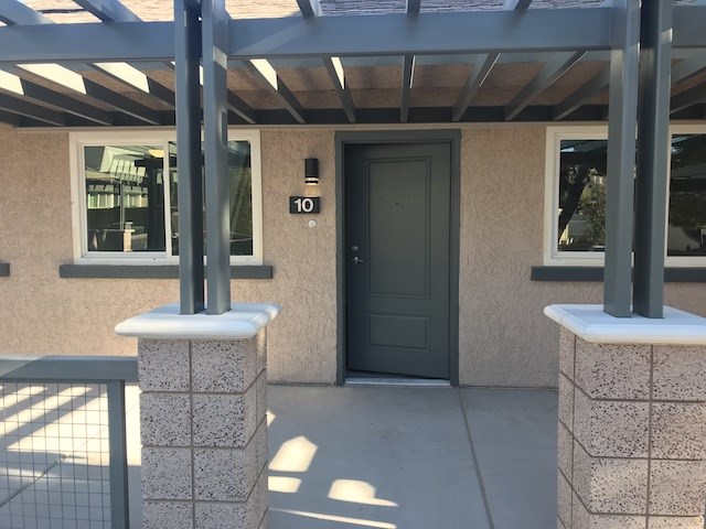 the front entrance of a building with a black door