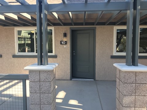 the front entrance of a building with a black door