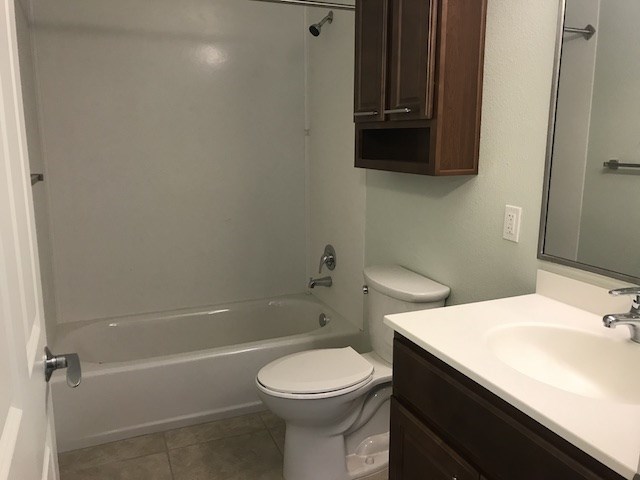 a bathroom with a toilet and a tub and a sink