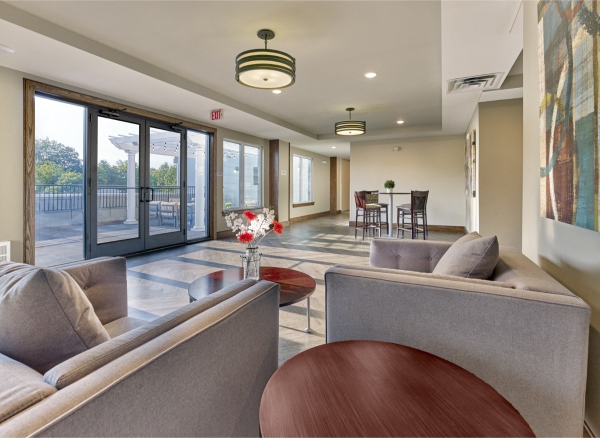 a living room with couches and chairs and a table