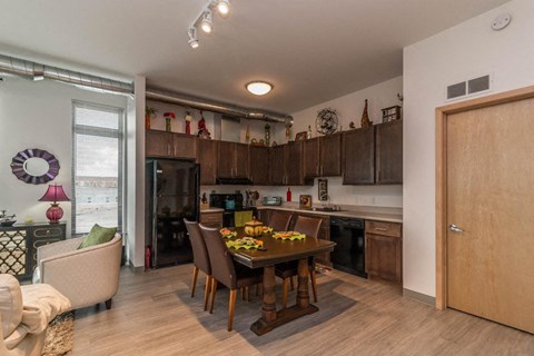 a kitchen and dining room with a table and chairs