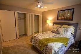 a bedroom with a bed and a ceiling fan
