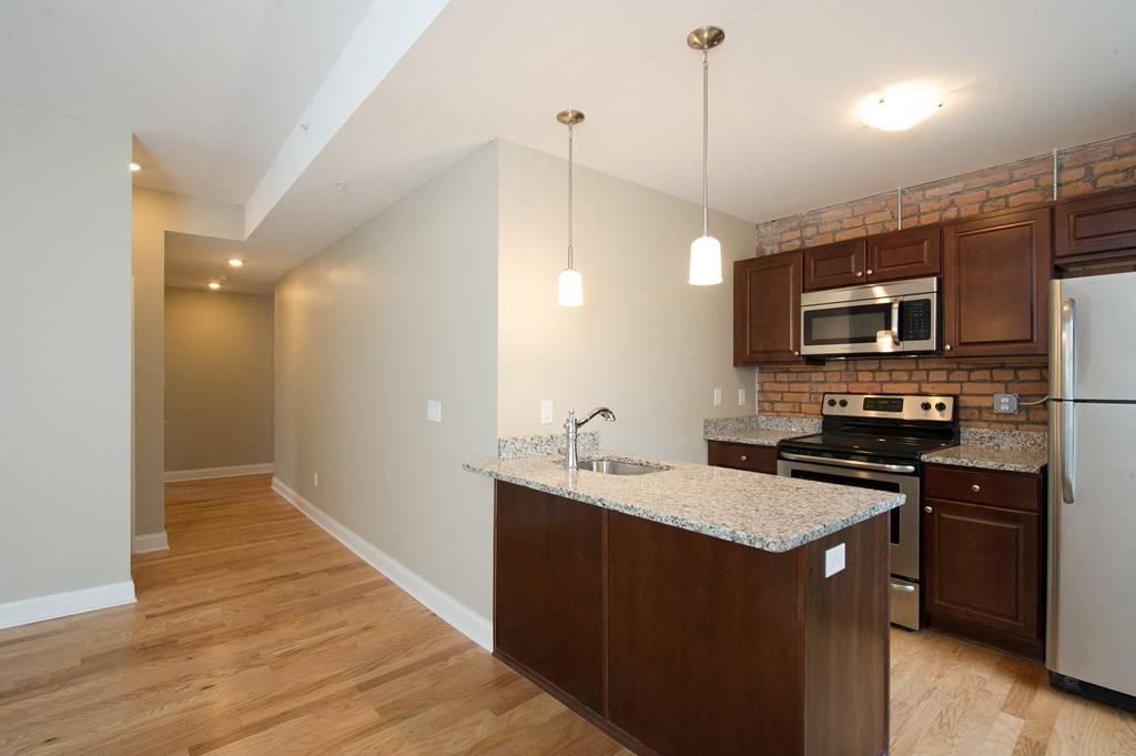 a kitchen with a granite counter top and stainless steel appliances