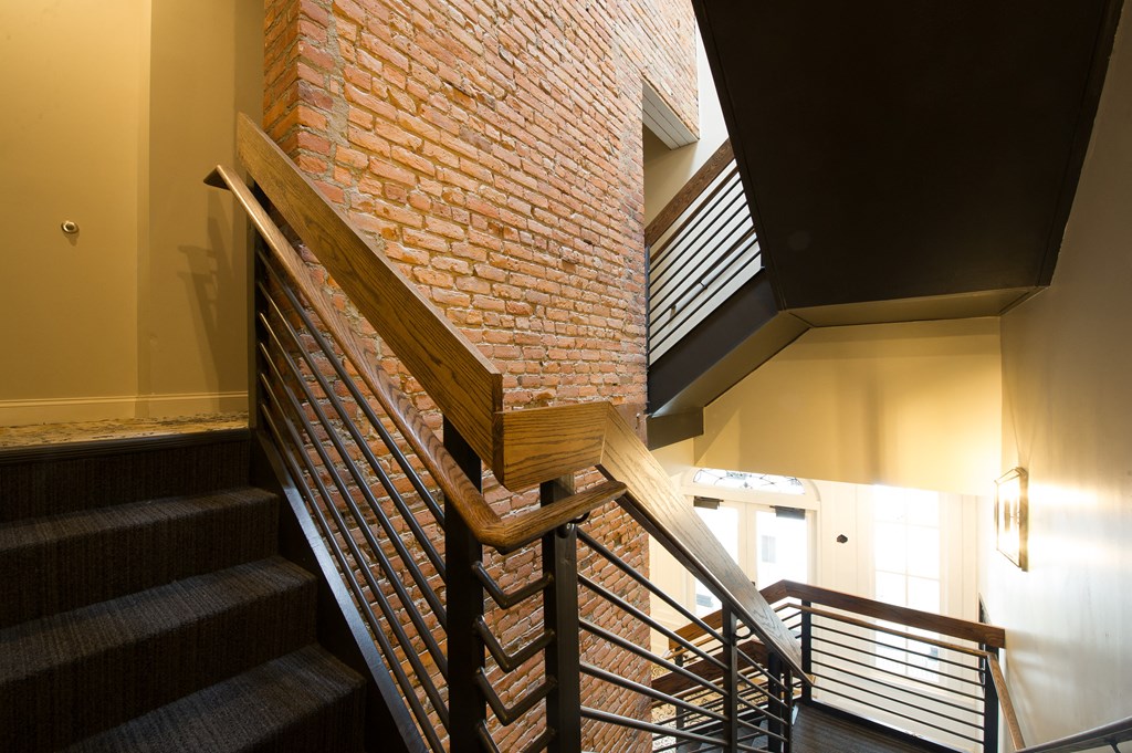 a staircase with a brick wall in a building with stairs