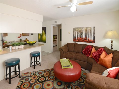a living room with a couch and a kitchen