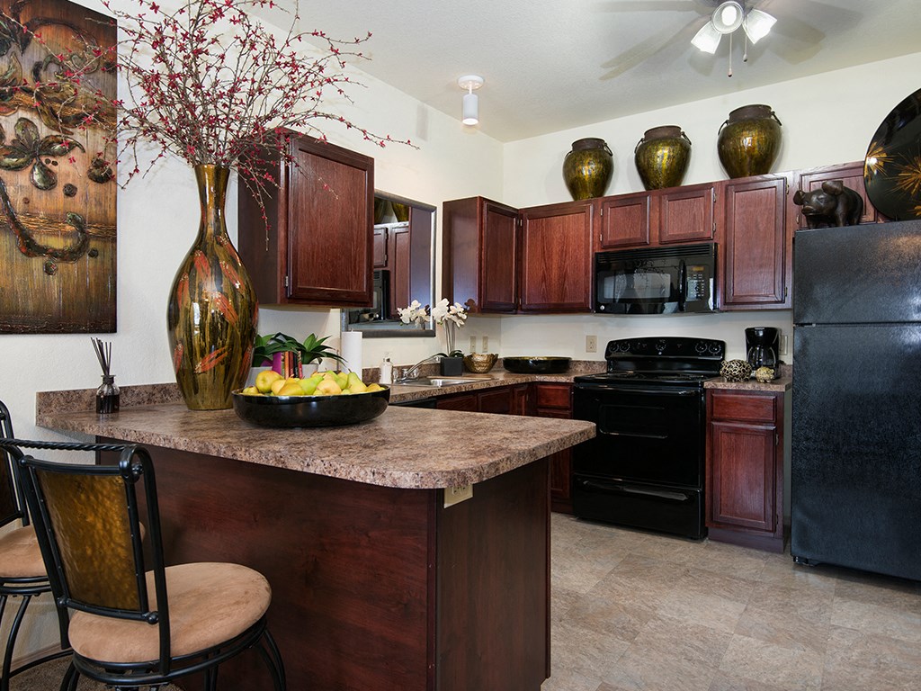 a kitchen with a counter with a bowl of fruit on it