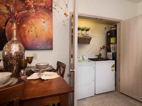 a kitchen and dining room with a table and a refrigerator