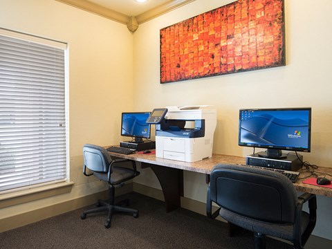 a office with two computer desks and two office chairs