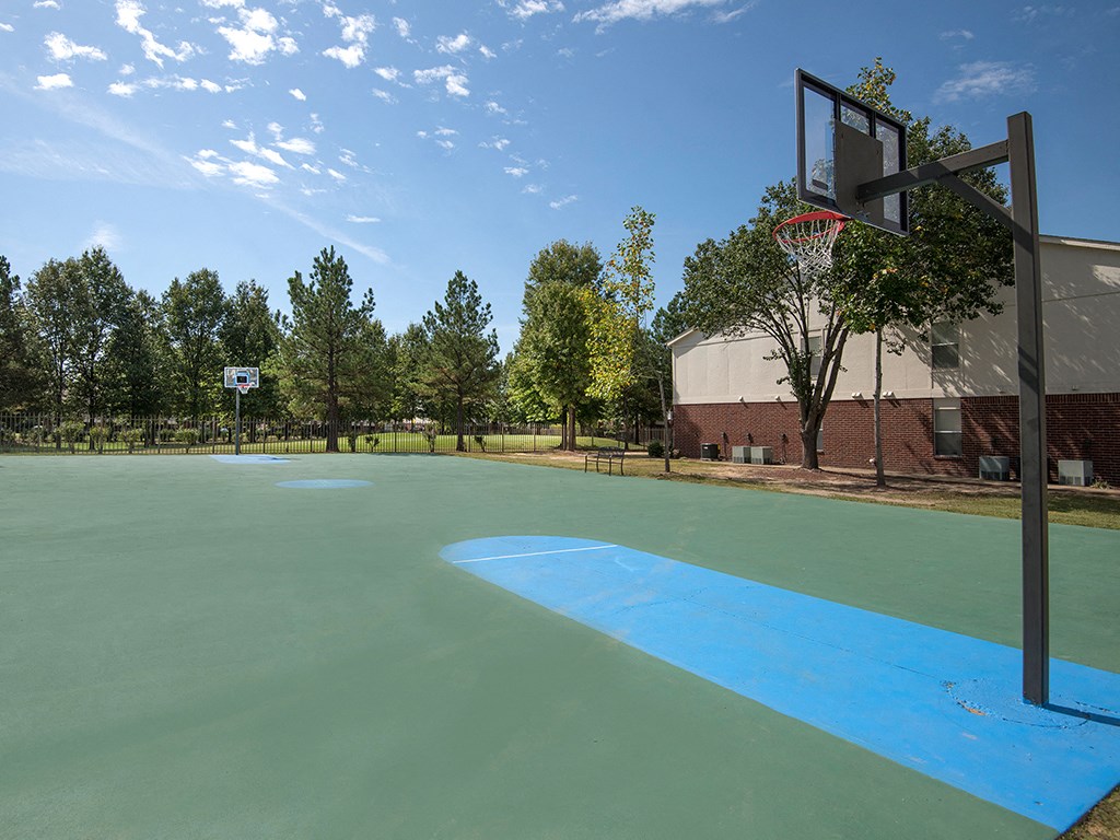 a basketball court at the commons on a sunny day