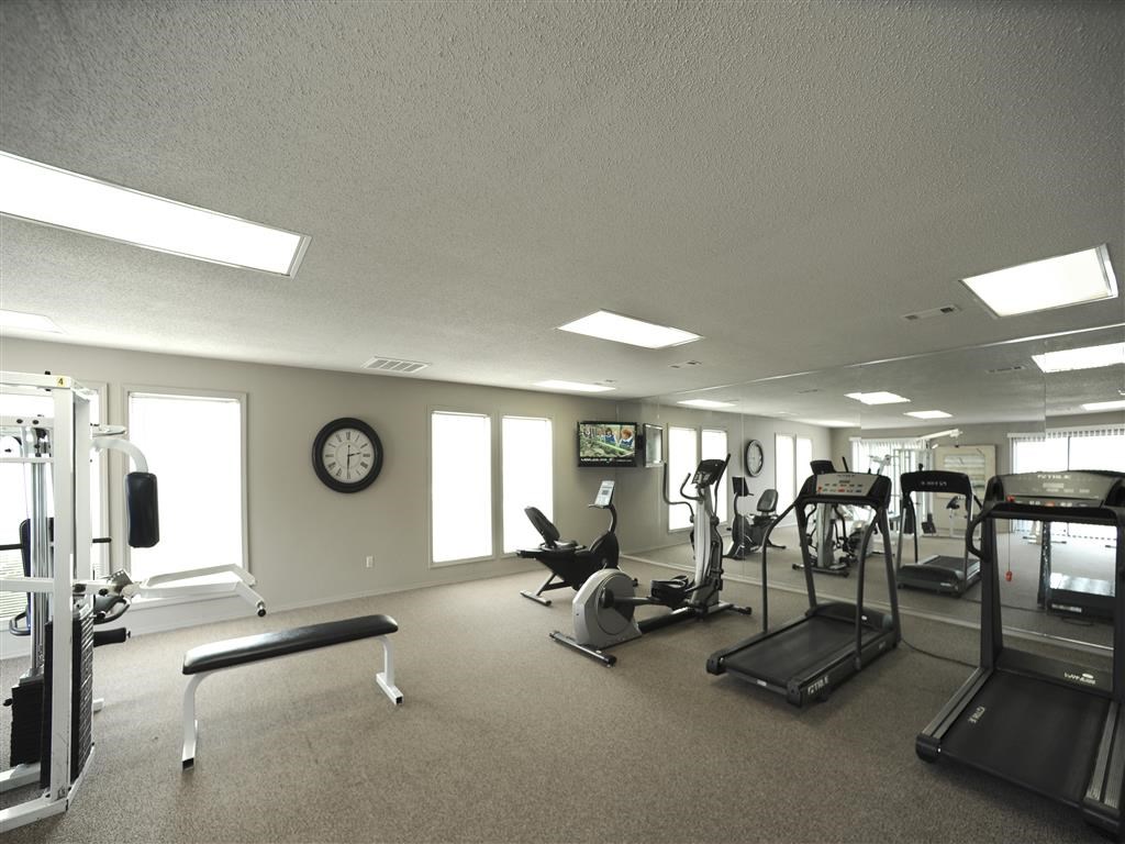 a gym with various exercise equipment in a large room