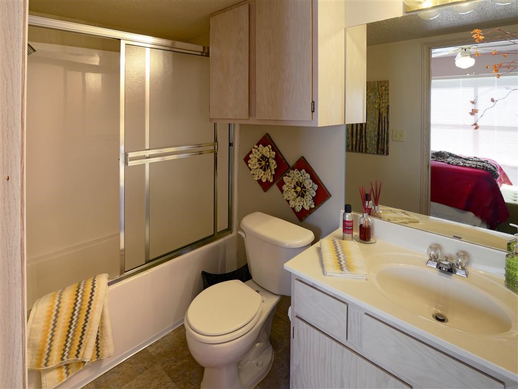 a bathroom with a toilet and a sink and a shower