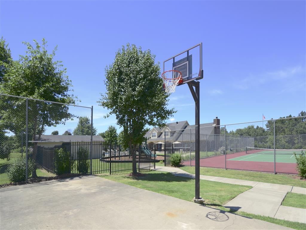 a basketball hoop on a pole next to a basketball court