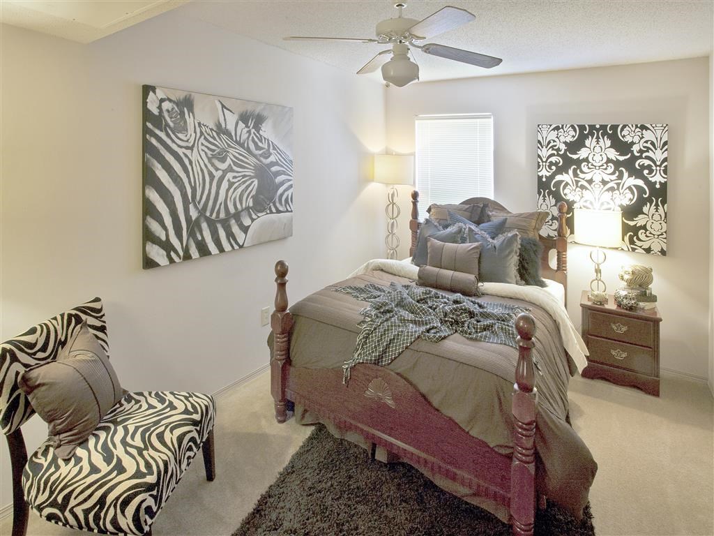 a bedroom with a bed and a ceiling fan