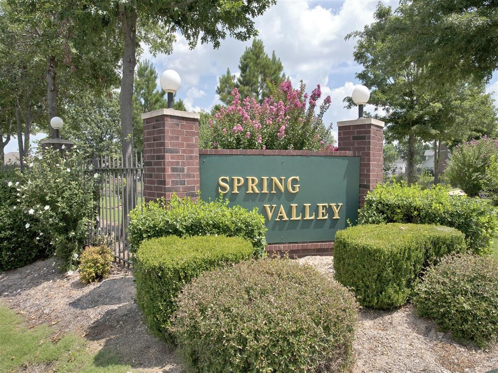a sign for spring valley at the entrance to a park