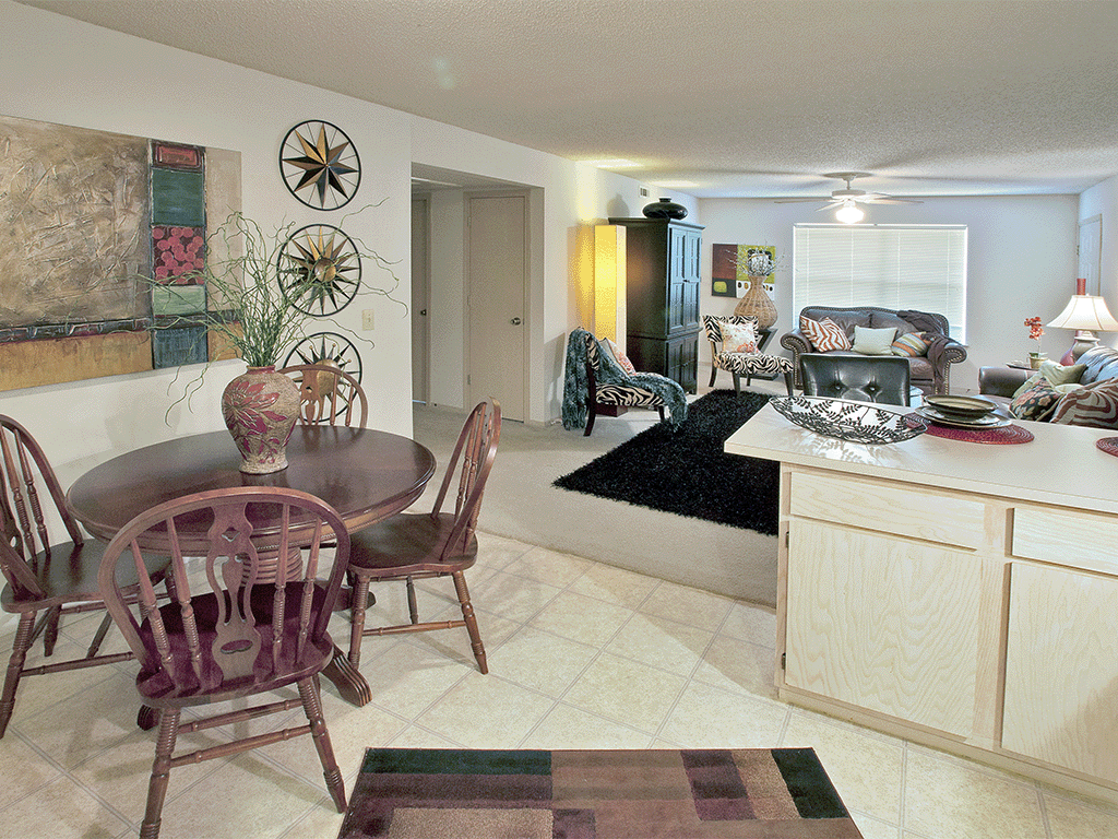 a dining room and living room with a table and chairs