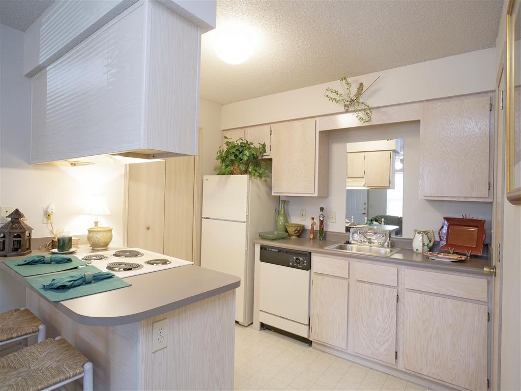 a kitchen with white appliances and a counter top