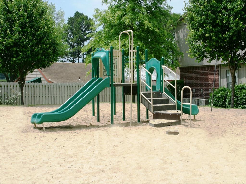 a playground with a slide in a park