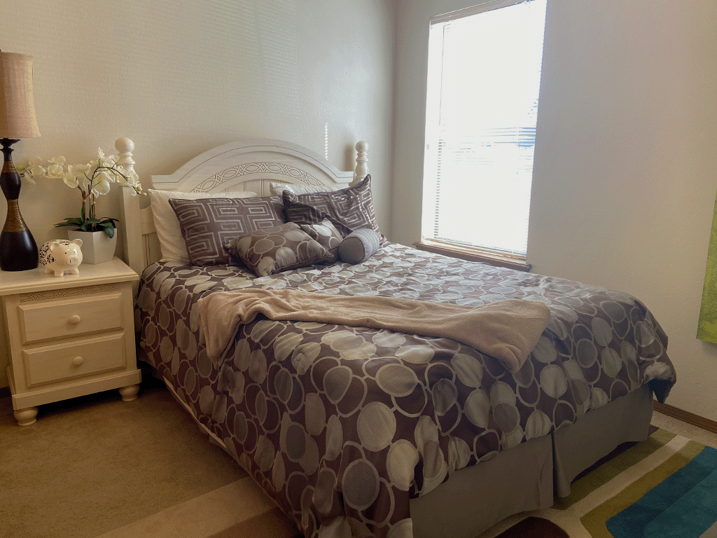 a bedroom with a bed and a window