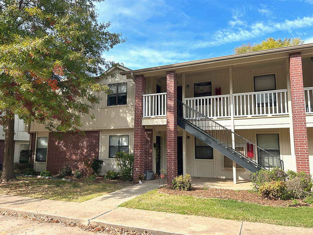 an exterior view of an apartment building with a staircase