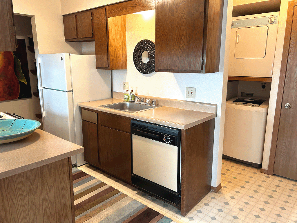 a small kitchen with a sink and a dishwasher